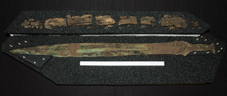 The 3,000-year-old bronze sword alongside the remnants of a sheath. (Image: GUARD Archaeology)
